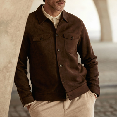 Man wearing a brown jacket with a blurred background